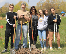 Frasson Family standing holding shovels